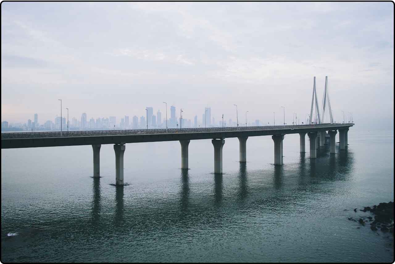 A bridge with intricate design over a peaceful body of water in India.